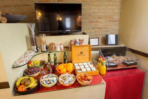 a buffet with fruit and other foods on a counter at Hotel Rural El Pilaret in Azanúy