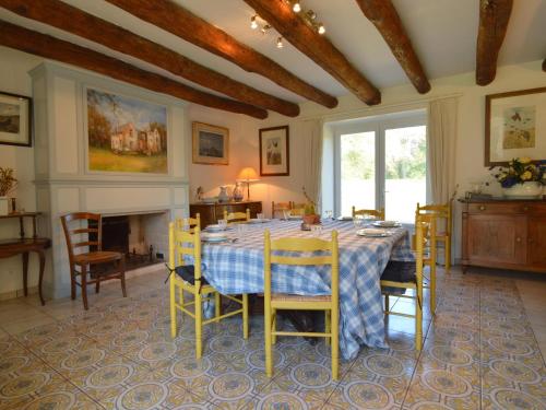 a dining room with a table and chairs at Spacious Holiday Home in Ass rac with a Fenced Pond in Assérac