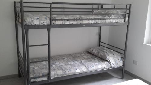 a couple of bunk beds in a room at Residenza Christian in Gravedona