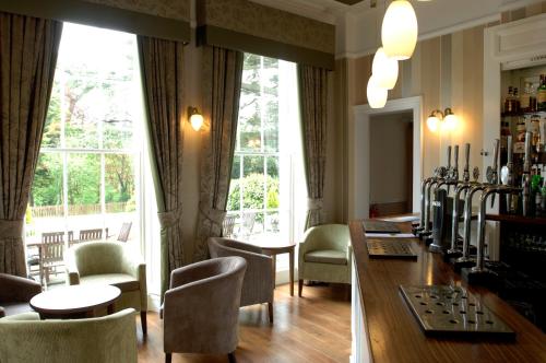 a bar with a chess board on a table and chairs at Lysses House Hotel in Fareham
