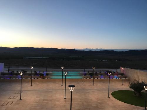 a group of lights in a courtyard with a pool at Casa Boquera in Carche