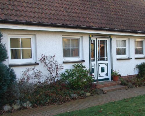 a white house with a blue door and windows at Ferienhaus Helene in Michaelsdorf