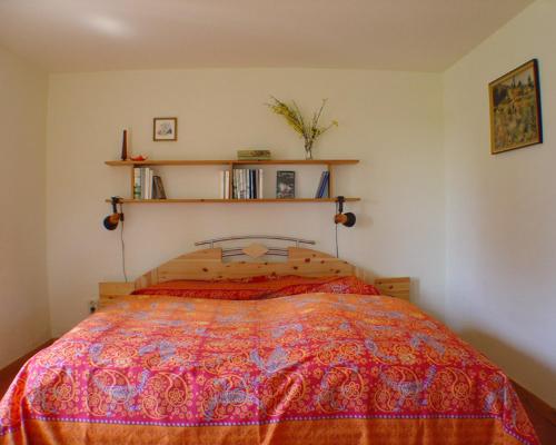 a bedroom with a bed with a colorful bedspread at Ferienhaus Helene in Michaelsdorf
