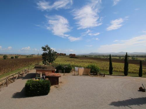 a patio with a view of a field of crops at Apartment near Lake Trasimeno vineyards in Strada
