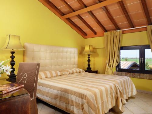 a bedroom with a large bed and a window at Quaint Holiday Home in Grosseto with Beach Nearby in Grosseto