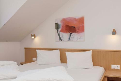 a bedroom with two beds and a painting on the wall at Haus Renate in Kaunertal