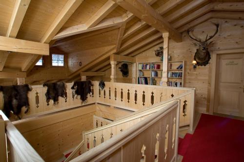 a large room with wooden ceilings and stairs in a cabin at Gämsle Hotel, Wirtshaus & mehr in Schoppernau