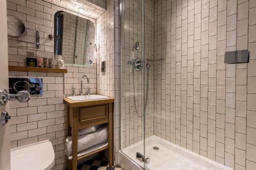 a bathroom with a shower and a sink and a tub at City Gate in Exeter