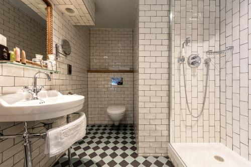 a bathroom with a sink and a shower and a toilet at City Gate in Exeter