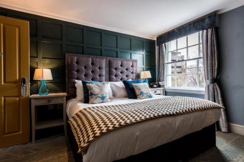 a bedroom with a large bed and a window at City Gate in Exeter