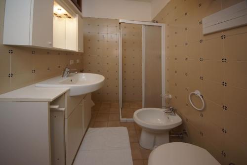 a bathroom with a toilet and a sink and a shower at Casa Vacanze Sole in Tremosine Sul Garda