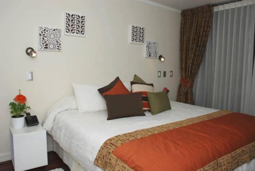 a bedroom with a large bed in a room at Puerta Arauco Apartamentos in Santiago