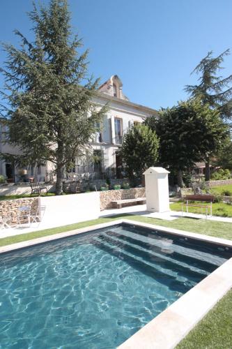 a swimming pool in front of a house at B&B en Provence- Villa Saint Marc in Forcalquier