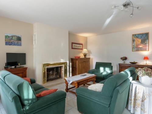 a living room with two green chairs and a fireplace at Elegant Escape in Lanrelas in Lanrelas