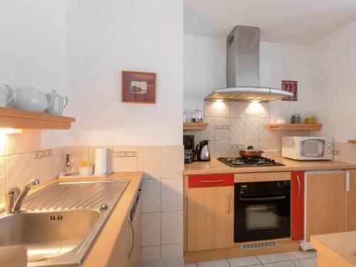 a kitchen with a sink and a stove top oven at Elegant Escape in Lanrelas in Lanrelas