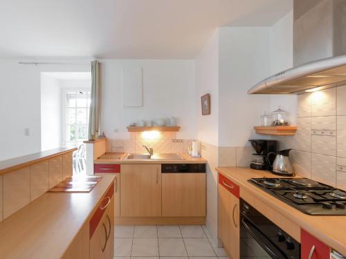 a kitchen with a sink and a stove top oven at Elegant Escape in Lanrelas in Lanrelas