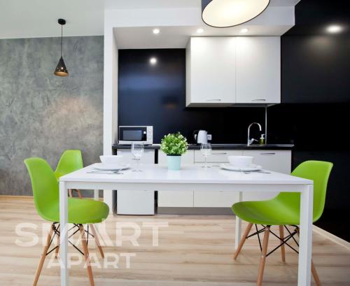 a dining room table and chairs in a kitchen at Smart Apart at Artek in Yekaterinburg