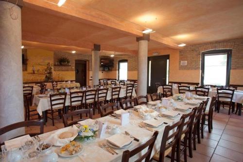 une grande salle à manger avec des tables et des chaises dans l'établissement Agriturismo Il Colore del Grano, à San Vittore