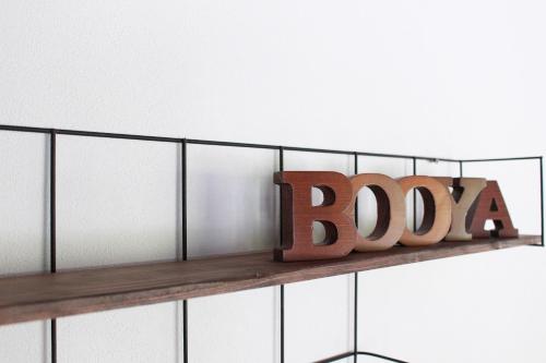 a wooden sign on a shelf in a bathroom at Nangoku Lodge Booya in Onna