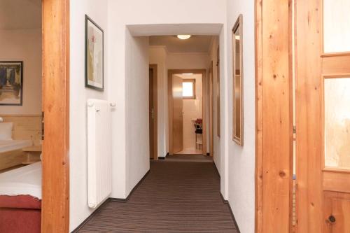 a hallway of a house with white walls and wooden floors at Haus Renate in Kaunertal