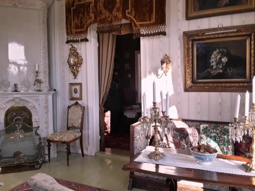 a living room with a couch and a table at Hotel Töyrylä Manor in Artjärvi