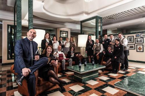 a group of people posing for a picture in a room at Etrusco Arezzo Hotel - Sure Hotel Collection by Best Western in Arezzo