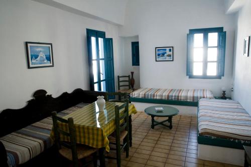 a living room with a table and a couch at Oias Sunset in Oia