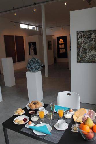 a black table with plates of food on it at B&B Het Museum in Berlaar