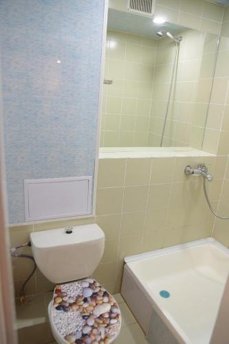 a bathroom with a toilet and a sink and a shower at Apartment on Samarqand Kochasi in Tashkent