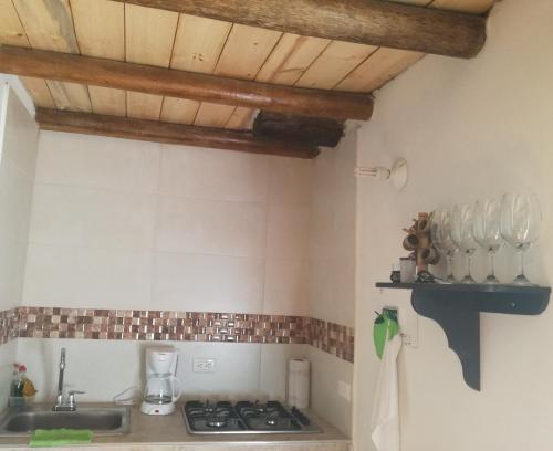 a kitchen with a sink and a stove at Cabaña Campestre San Fernando in Iza