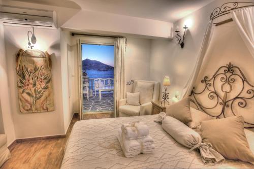a bedroom with a bed with a view of the ocean at Villa Isabella in Naousa