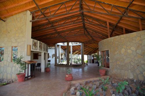 a large building with a wooden ceiling and a lobby at Ashnil Samburu Camp in Archers Post