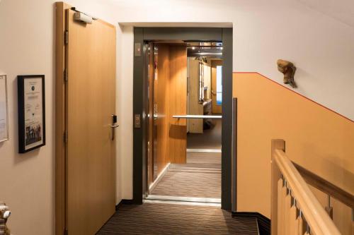 a hallway with a door and a stairway at Haus Renate in Kaunertal