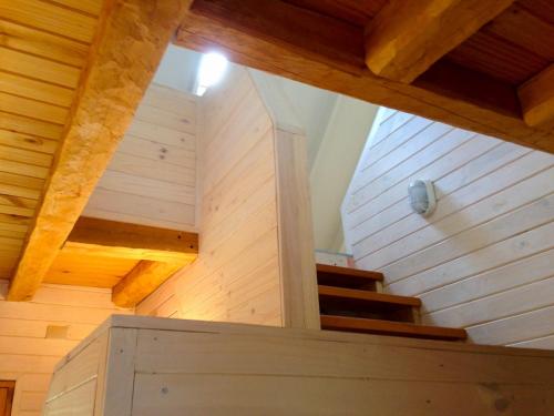a staircase in a house with wooden floors and wooden ceilings at Casa Cerro Castillo in Villa Cerro Castillo