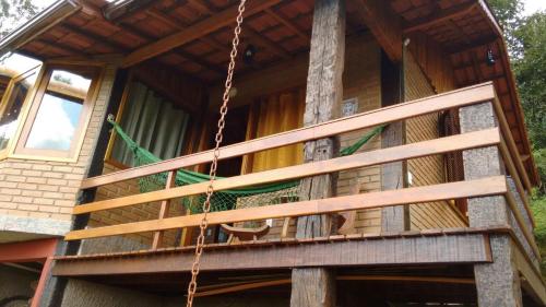 a porch swing in a tree house at Chalés de Analuz in Visconde De Maua