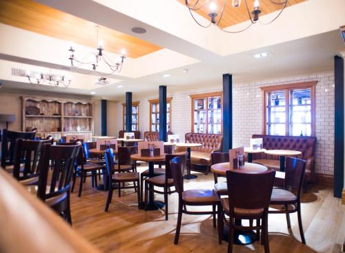 a dining room with wooden tables and chairs at Palm Court Hotel in Aberdeen