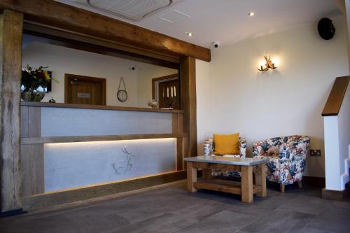 a salon with a sliding door and a chair at The White Hart Inn in Alfreton