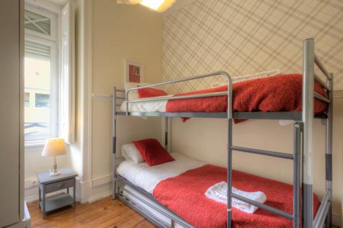a room with two bunk beds with a window at Angola Apartment - 8Bedrooms in Lisbon
