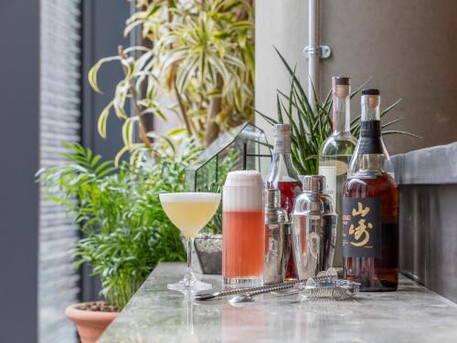 a table with bottles of alcohol and a drink at Leman Locke in London