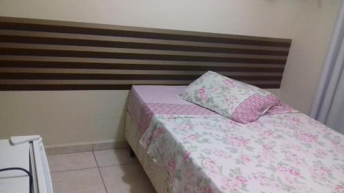 a bed with two pillows on top of it at Pousada Mãe Ternura Palace in Aparecida
