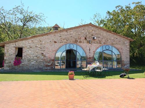 a brick building with a table and chairs in front of it at Belvilla by OYO Casa Rovello in Todi