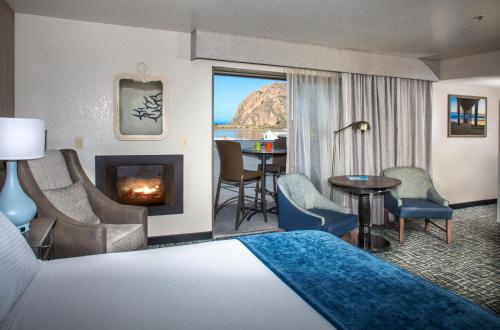 a hotel room with a bed and a fireplace at Blue Sail Inn in Morro Bay