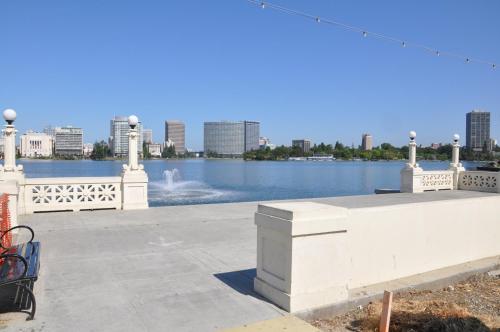 a white bench next to a body of water at Americas Best Value Inn - Downtown Oakland/Lake Merritt in Oakland