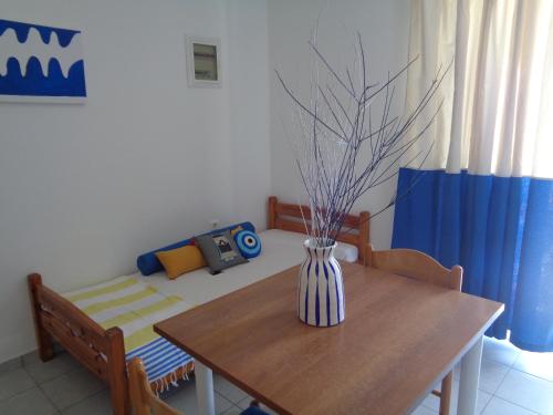 a vase sitting on a wooden table in a room at Gaitani Studios in Lentas