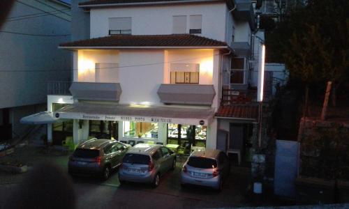 a group of cars parked in front of a building at Hospedaria Nunes Pinto in Termas de Sao Pedro do Sul