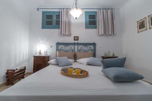 a bedroom with a bed with a bowl of food on it at Alma Libre Villas in Kastraki Naxou