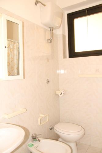 a bathroom with a toilet and a sink at Roberta Apartment in Marcelli