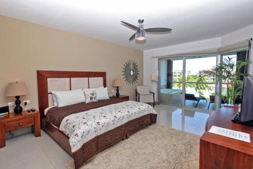 um quarto com uma cama e uma ventoinha de tecto em Condo Buena Vida - Luxury Ocean View at Mareazul em Playa del Carmen