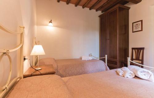 a hotel room with two beds and a lamp at Borgo Nuovo San Martino in Ambra