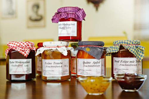 a group of four bottles of honey on a table at Ferien Weingut Schneider in Ellenz-Poltersdorf